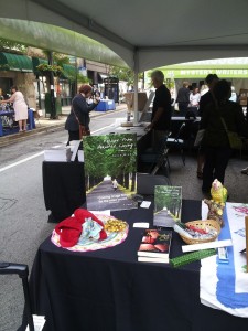 Here's my book sales booth at Printers Row Book fest in Chicago in June. Note the fuzzy slippers, hankie and candy representing assisted living! People loved it. My good friend Stephanie Medlock was next to me selling her book The Lives of Things.
